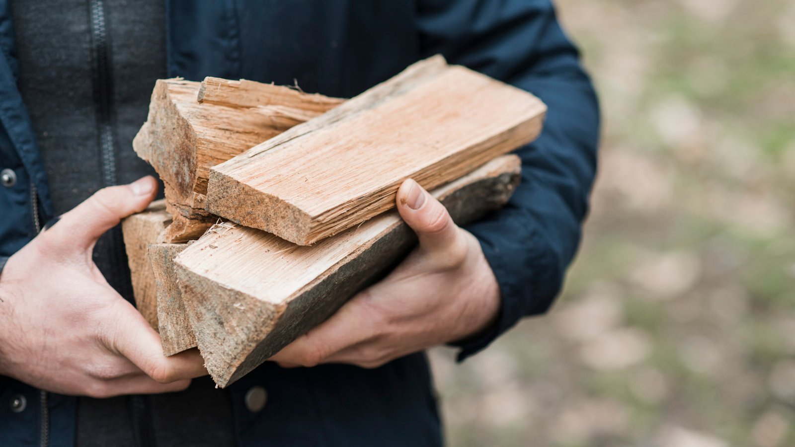 close up man carrying wood 1 scaled.jpg